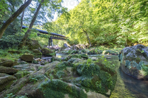 The Irrel Waterfalls, rapids in the lower reaches of the Prüm, covered wooden bridge for hikers, between Prümzurlay and Irrel, in the Eifel district of Bitburg-Prüm, Rhineland-Palatinate. Germany