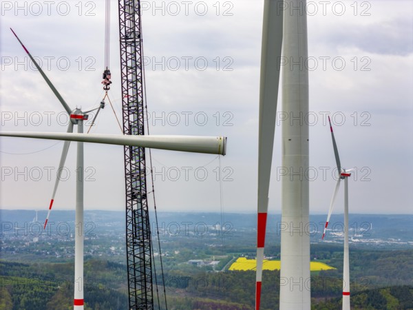 Erection of a wind turbine, wind energy plant, assembly of the third blade, with a crawler lattice crane, wind farm near Hagen, North Rhine-Westphalia, Germany, Europe