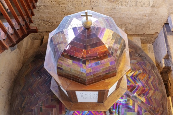 Colourful church dome with stained glass and a cross, geometric patterns and bright colours, Cordoba