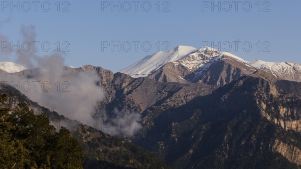 Mountains with snow-covered peaks and some clouds in a calm, natural atmosphere, Omalos Plateau, entrance to Samaria Gorge, Lefka Ori, White Mountains, mountain massif, west, Crete, Greece, Europe