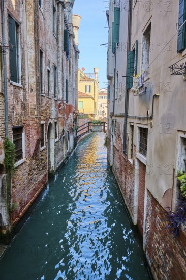 View on small bridge with the inscription 'Poste Vecie' going over a waterway in Venice on a sunny day in winter, Italy, Europe