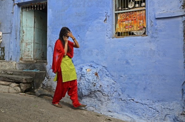 Woman walking in narrow lane, Jodhpur, Rajasthan, India, Asia