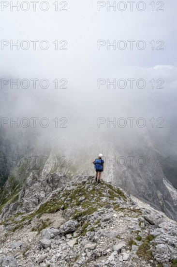 Mountaineer in fog, bad weather, Wetterstein Mountains, Garmisch-Patenkirchen, Bavaria, Germany, Europe