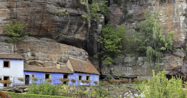 The blue troglodyte houses in rock face at Graufthal, Vosges, Alsace, France, Europe