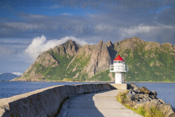 Lighthouse at harbour wall, fishing village Hovden, island Langøya, archipelago Vesterålen, Norway, Europe