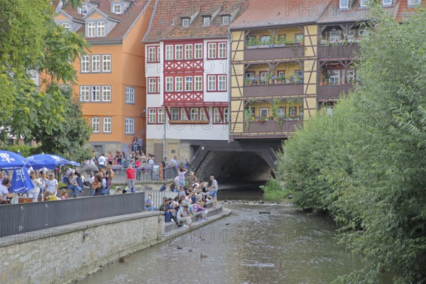 Famous Krämerbrücke and with river Gera and people sitting on the bank, idyll, half-timbered houses, bridge houses, Erfurt, Thuringia, Germany, Europe
