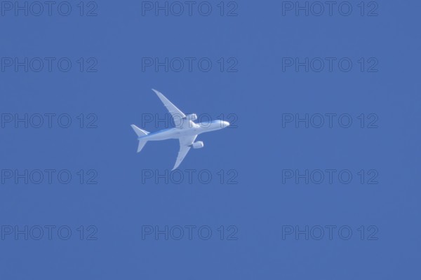 Boeing 787-8 Dreamliner jet aircraft of TUI airlines flying in a blue sky, England, United Kingdom, Europe