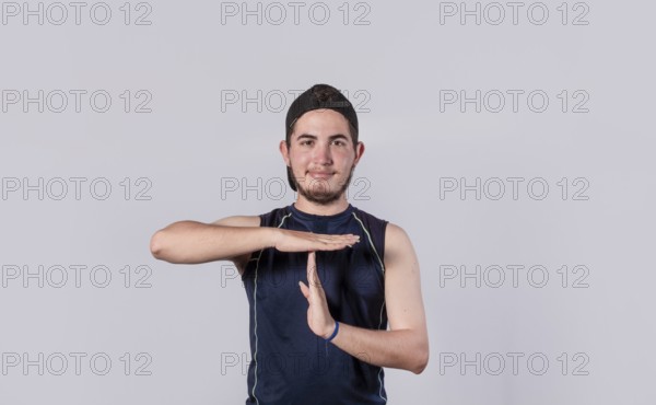 Man making time out gesture, latin guy making time out gesture