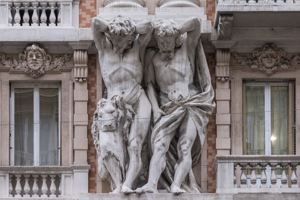 Two atlases on a historic house facade, Genoa, Italy, Europe
