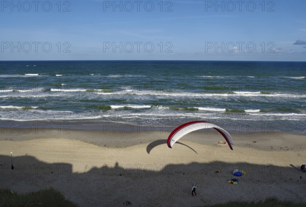 Paraglider soaring over a wide beach with blue sea, North Sea, Lokken, North Jutland, Jutland, Denmark, Europe