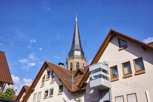 Church tower of St. Nikolaus, residential building, pointed roof with red roof tiles, frog perspective, blue sky with cumulus clouds, Kappelrodeck, Black Forest, Ortenaukreis, Baden-Württemberg, Germany, Europe