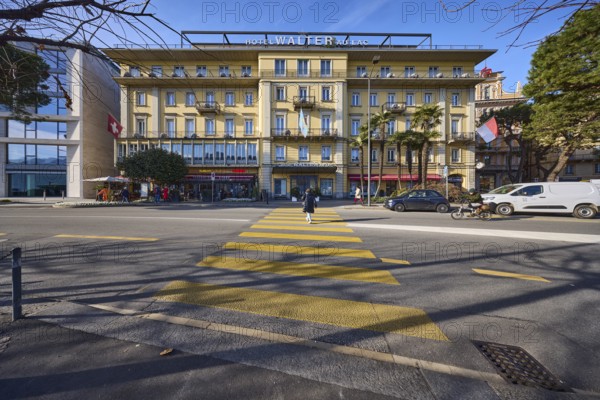 Hotel Walter Au Lac, pedestrian crossing, building, trees, pedestrians as accessories, street Riva Vincenzo Vela, Lugano, district Lugano, canton Ticino, Switzerland, Europe