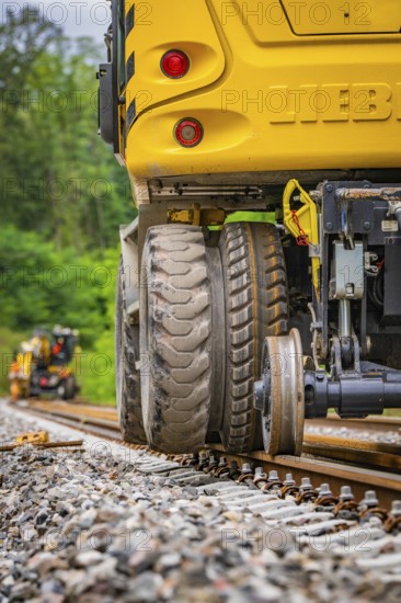 Close-up of a construction machine working on rails in a forest landscape, track construction, Hermann Hessebahn, Calw, Black Forest, Germany, Europe