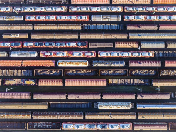 Deutsche Bahn AG marshalling yard. Many goods trains are parked on the tracks with tank wagons, car transporters and other wagons, companies transport a considerable part of their freight by rail, aerial view, Germany, Europe
