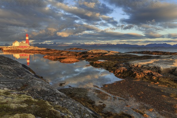 Lighthouse reflected in water, morning light, clouds, mountains, coast, Tranoy, Ofoten, Norway, Europe