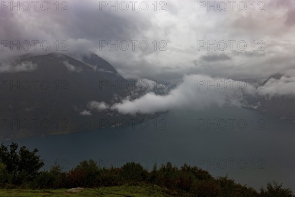 Aerial View over Lake Lugano in Valley with Mountainscape with Storm Clouds in Lugano, Ticino, Switzerland, Europe