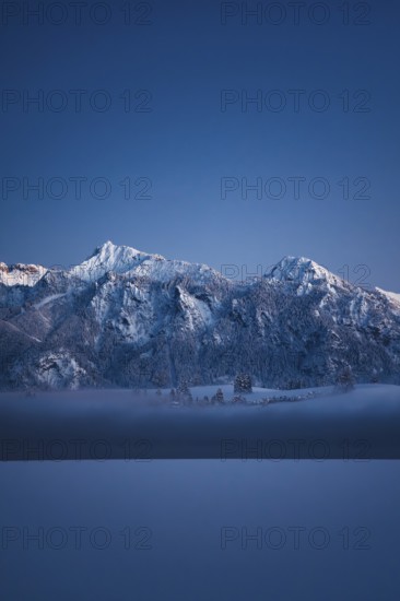 Shortly after sunset, twilight at Lake Hopfensee in the Allgäu in Bavaria in a winter landscape, Germany, Europe
