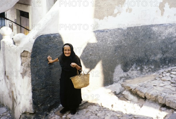 Old widow in black clothes in Ibiza Town, Ibiza, Balearic Islands, Spain 1967