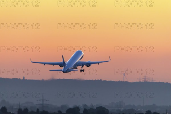 Passenger aircraft after take-off, in front of sunrise, Baden-Württemberg, Germany, Europe
