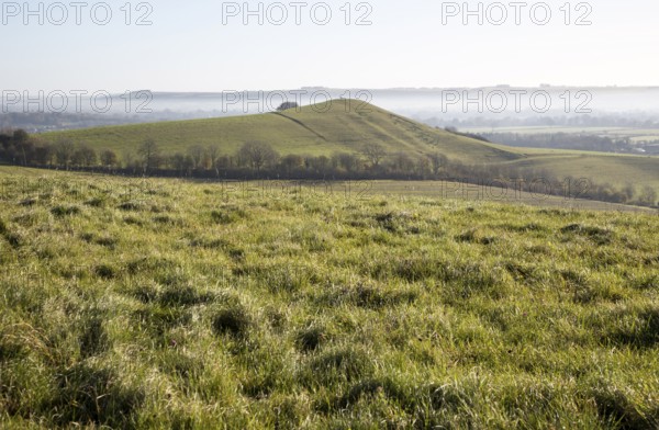 Picked Hill chalk outlier landscape misty valley floor, Vale of Pewsey, from Woodborough Hill, Wilcot, Wiltshire, England, UK
