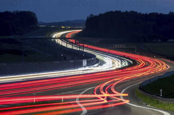 Tracers on the A8 motorway, winding road, evening, long exposure, Swabian Alb, Baden-Württemberg, Germany, Europe