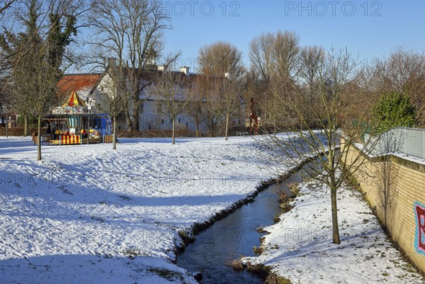 Dortmund, North Rhine-Westphalia, Germany, winter with snow in the Ruhr area, renaturalised Emscher in Dortmund-Aplerbeck at the moated castle Haus Rodenberg (left), Europe