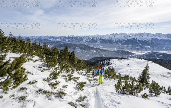 Ski tourers climbing Simetsberg, view of mountain panorama, Estergebirge, Bavarian Prealps, Bavaria Germany