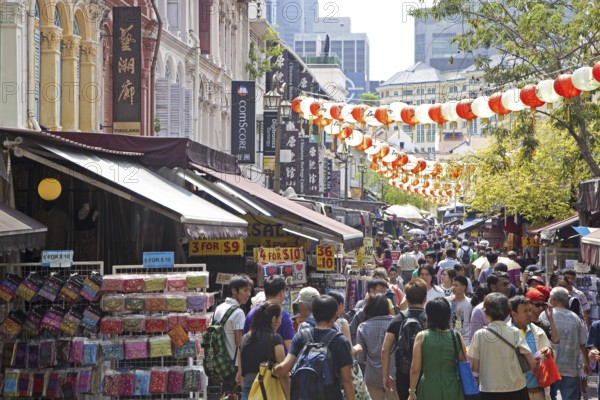 Pedestrians shopping in the colourful Chinatown neighbourhood in Singapore