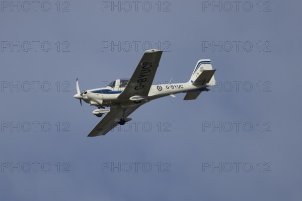 Grob G115E Tutor aircraft flying in a blue sky, England, United Kingdom, Europe