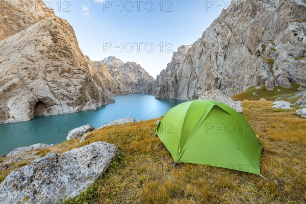 Green tent at the turquoise mountain lake Kol Suu with rocky steep mountains, Kol Suu Lake, Sary Beles Mountains, Naryn Province, Kyrgyzstan, Asia
