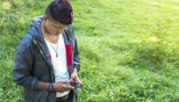 Close up of a man with cell phone in hand, close up of hands with cell phone with white screen, young guy with cell phone in hand with copy space