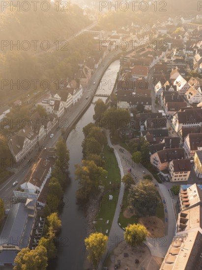 Aerial view of a town with a river and residential buildings, illuminated by the sunset, Calw, Black Forest, Germany, Europe