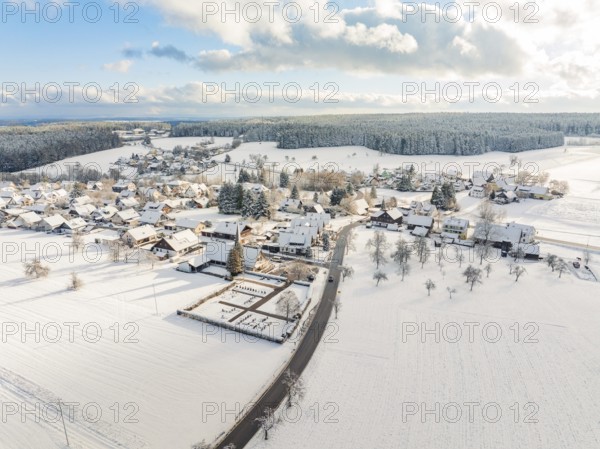 Snow-covered village with streets and buildings under a cloudy sky, Oberreichenbach, Black Forest, Calw district, Germany, Europe