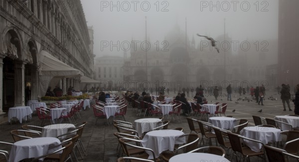 Italy Venice St Mark's Square -46 Café Lavena outdoor seating on a foggy November day behind St Mark's Basilica and Campanile