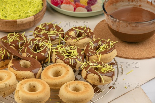 Donuts half dipped in chocolate, decorated with sprinkles