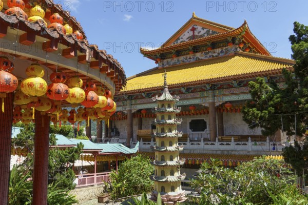 View of a temple complex with a pagoda and colourful lanterns. Embedded in lush nature, penang, malaysia