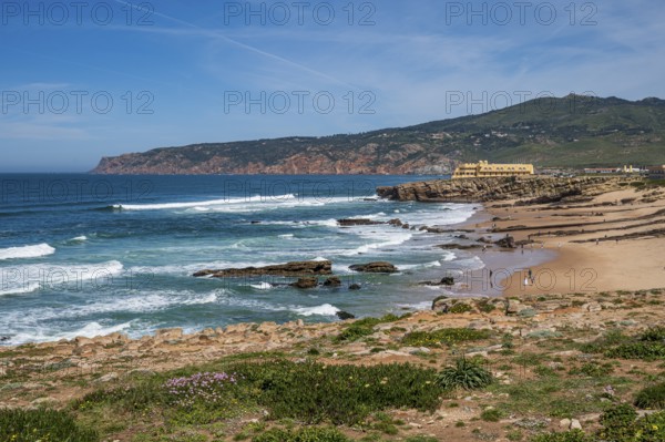 Wide coastal landscape with beach, rocks and sea under a clear sky, coast in Portugal Praia de Arriba