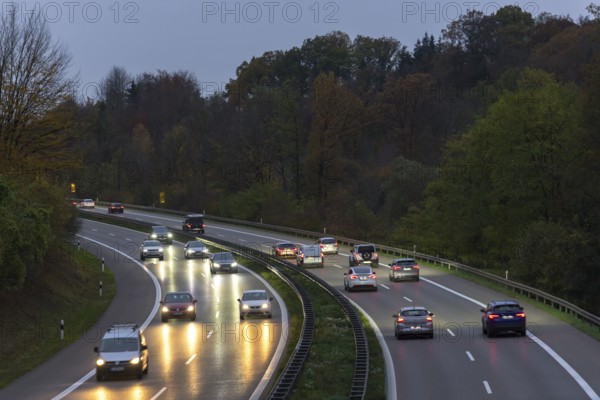Traffic on a wet motorway at dusk, surrounded by trees, Rems-Murr district, Baden-Württemberg, Germany, Europe