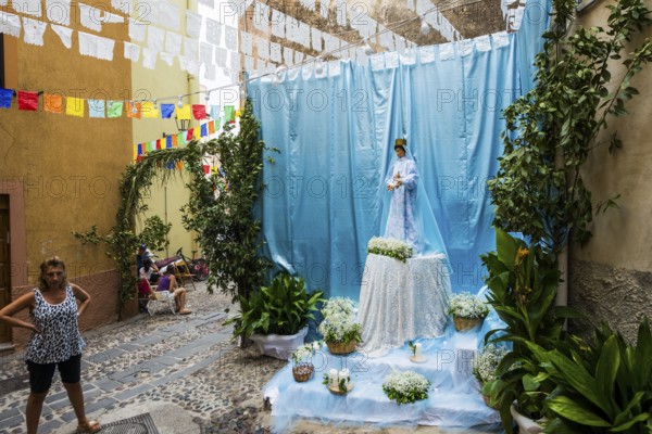 Decorated alley and celebrating people, feast of the Madonna of Regnos Altos, Bosa, district of Oristano, Sardinia, Italy, Europe