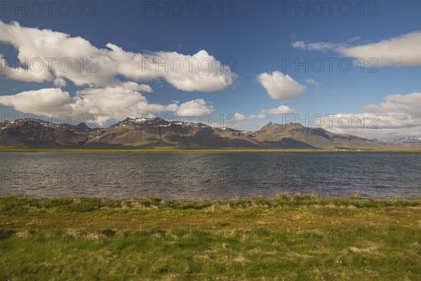 Lake and mountains at Ytri Tunga, West Iceland. Sunny day with blue sky and some clouds