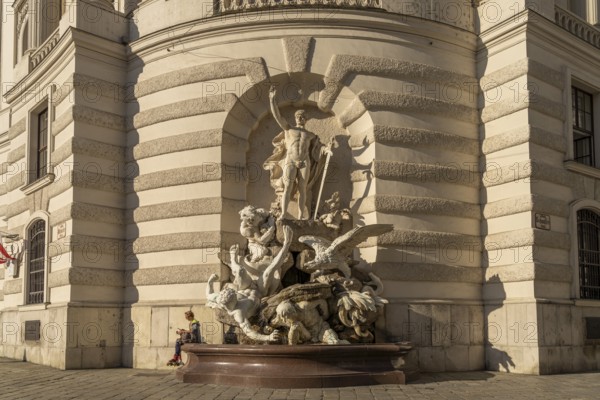 Fountain sculpture Die Macht zu Lande, St Michael's Wing of the Hofburg Imperial Palace Palace in Vienna, Austria, Europe