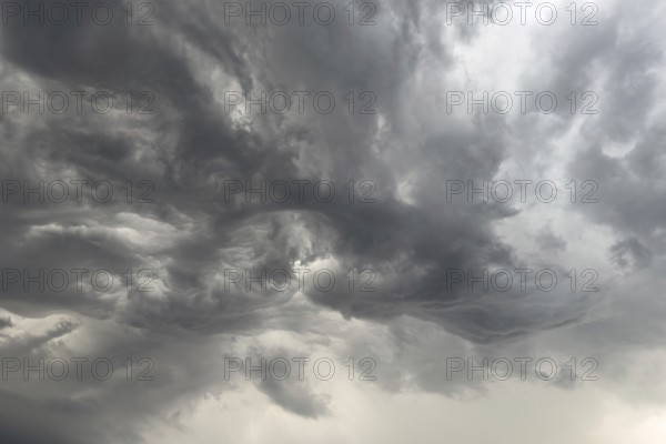 Cloud formation after storm warning thunderstorm warning grey dark clouds shortly in front of thunderstorm swirled by storm torn clouds thunderclouds, North Rhine-Westphalia, Germany, Europe