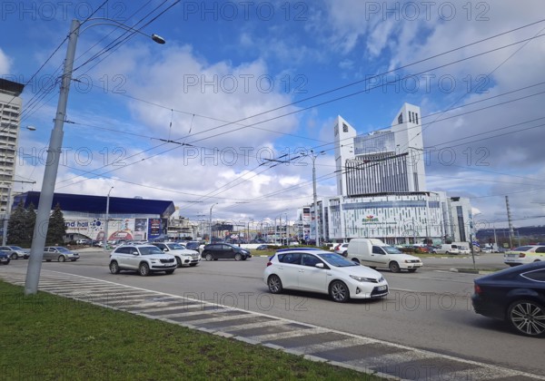 CHISINAU, MOLDOVA, March 20, 2024 city traffic during rush hour in the morning at the roundabout with a view to the Atrium shopping center