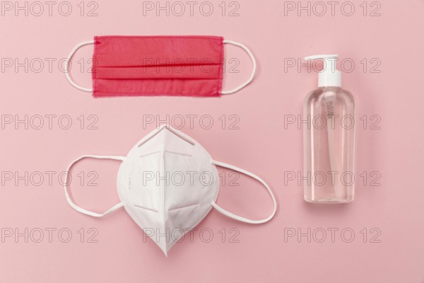 Top view medical masks with disinfectant bottle