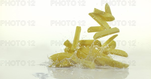 French Fries, Charlotte Potato (solanum tuberosum), Vegetable falling on Water against White Background