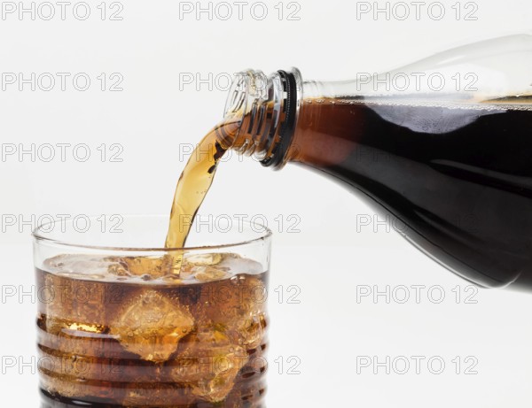 Front view soft drink being poured glass