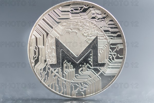Monero. Crypto currency silver coin, Macro shot of Iota coin isolated on background, cut out