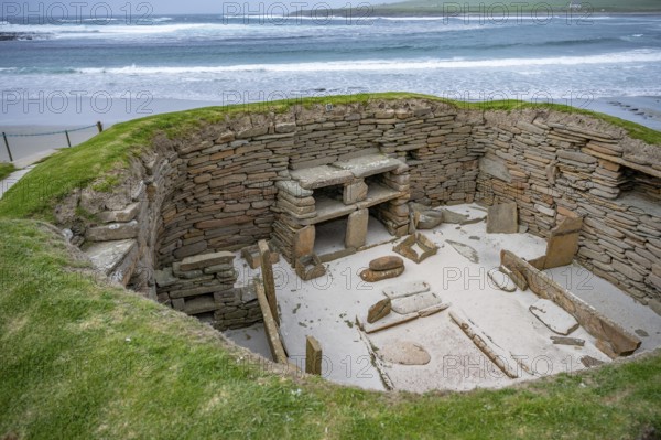 Skara Brae prehistoric village at Orkney Island, wide angle shot, sea in the background, Scotland, United Kingdom, Europe