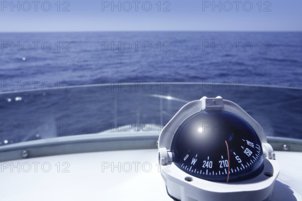 Compass on a yacht boat tower on a blue summer sea ocean day