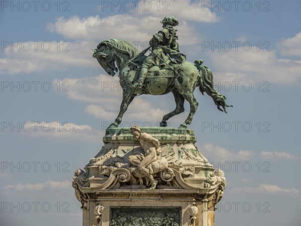 Equestrian statue made of stone under a blue sky in Budapest, budapest, danube, hungary
